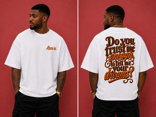 Black male model wearing the love is. oversized cotton t-shirt featuring the “Do You Trust Me Enough To Tell Me Your Dreams?” graphic design.