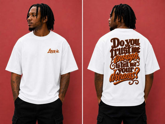 Black male model wearing the love is. oversized cotton t-shirt featuring the “Do You Trust Me Enough To Tell Me Your Dreams?” graphic design.