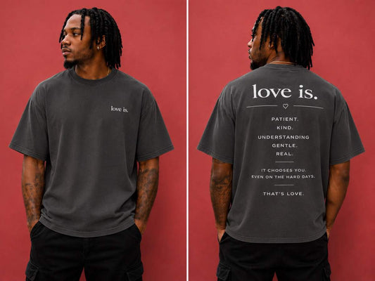 Male model wearing the love is. oversized faded charcoal t-shirt featuring a minimalist front logo and inspirational back design promoting patience, kindness, understanding, gentleness, and authentic love.