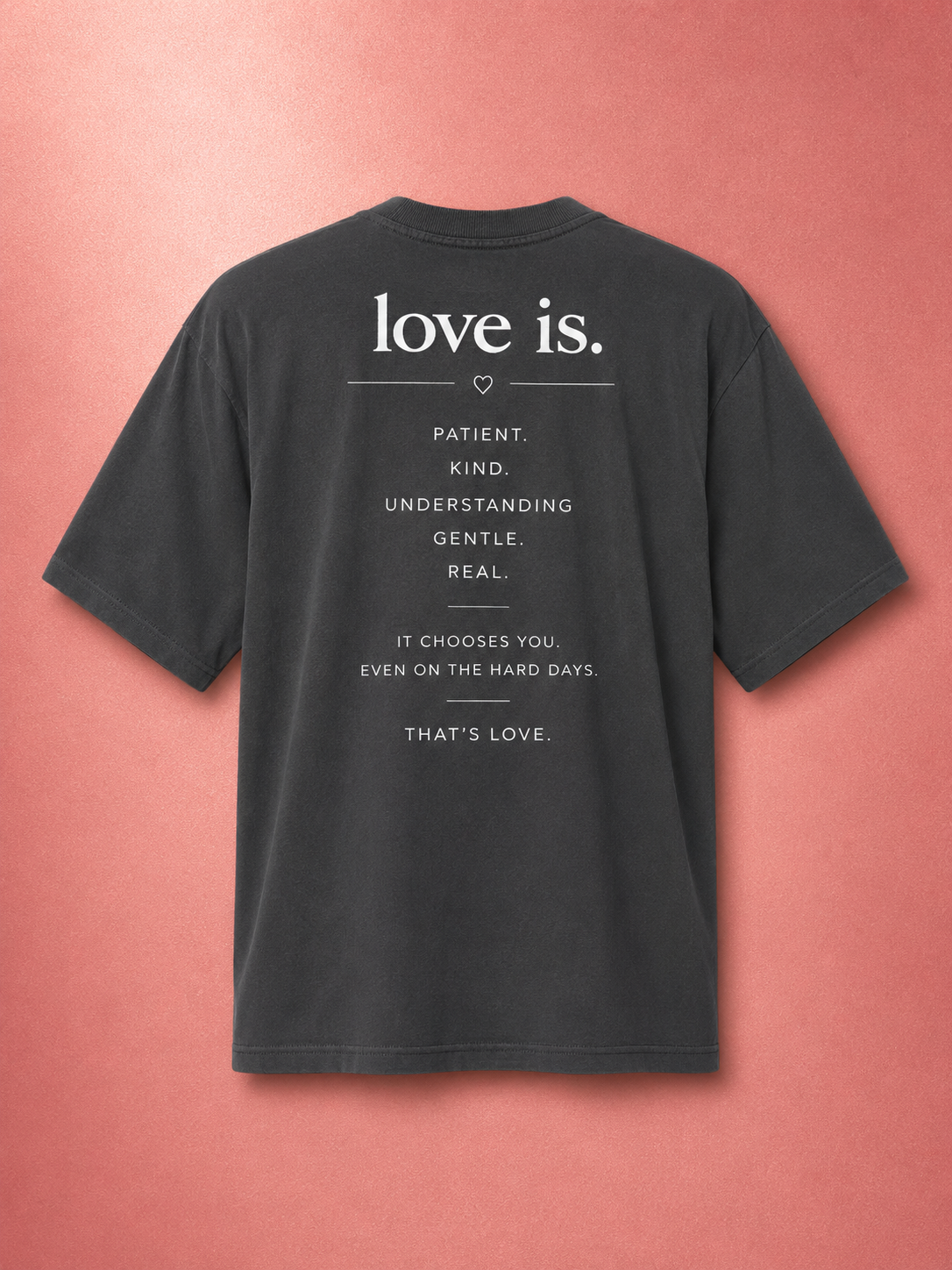 Black oversized faded t-shirt featuring the love is. design with the words patient, kind, understanding, gentle, and real on the back. Inspirational Christian streetwear apparel promoting faith, love, and biblical values.