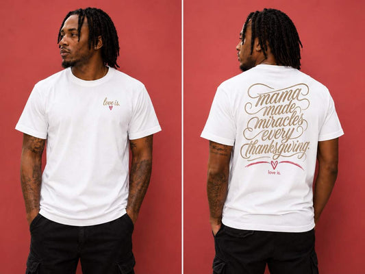Male model wearing a white graphic tee featuring the "Mama Made Miracles Every Thanksgiving" love is. design on the back