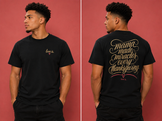 Male model wearing a black  graphic tee featuring the "Mama Made Miracles Every Thanksgiving" love is. design on the back