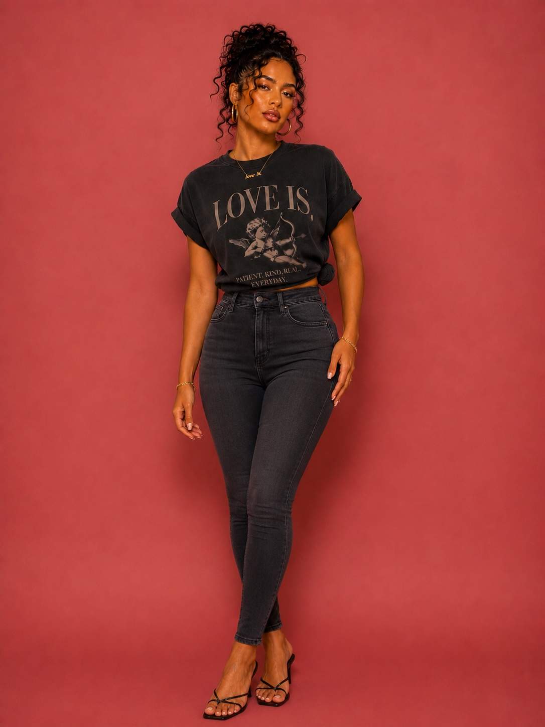 Female model wearing a vintage oversized Cupid graphic tee featuring the "Patient. Kind. Real. Everyday." love is. design
